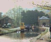 Cromford in the 1980's. The vessels shown are as follows (nearest first):  Smalley excavator mounted on purpose-built (by Smalley) pontoon with hydraulic stabilisers; The Duchess (now being used for coal by the pump group);  in the distance the bows of John Gray, the horse drawn trip boat