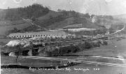 A view of the Ambergate lime kilns which once stood beside the canal where the gas works site now severs the route and causes the towpath to be diverted up the hillside behind. The diagonal track beyond is the line of Stevenson's rope-worked incline by which railway wagons loaded with limestone were lowered from the Crich quarries, across the canal (the level of which is just discernible as a hoizontal line at the level of the top of the kilns) to the kilns