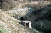 This picture shows the second portal (built when the tunnel was extended over the railway) in Sping 1976 - the marker boards indicate the eventual extent of the A38 embankment