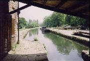 Looking through the newly built canopy at the top of Cromford Wharf. This was rebuilt to original photos by CCS and a job creation scheme. Our work boat is midground left and behind it are the 'Duchess' and the floating dredger. On the right is the dismantled cast iron swingbridge rescued from Bull Bridge Aqueduct.