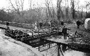 THE MAIN SPAN - the two largest girders, which took ten men to lift, are bolted into position. There are internal spreaders to maintain rigidity of the bridge, and the hand rails are bolted to the main girders.