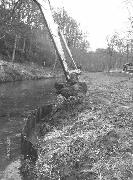 A small leak in the towpath near the Iron Aqueduct. This leak was topped with a few piles, and then backfilled.