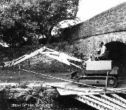 Grattons Bridge near the Naturalist's house. The Smalley long-reach tracked machine here is on loan. The lid of the machine had to be removed and steel beams laid under the bridge to provide access to the canal. This machine cleared much of the channel between Whatstandwell and Ambergate. (Photo supplied by Smalley Excavators)