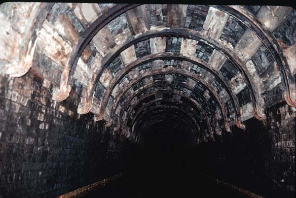 Rail extension, curved steel supports backed by wood