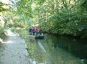 The work boat being hauled along on a long rope. No horses here, this is being pulled by willing volunteers!