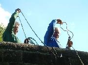 Dredging reeds from the canal bed using grapples from the bridge.