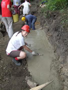 Bryony completes the concreting ready for stone laying the following day 