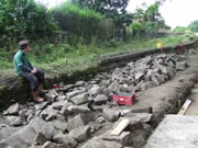 With stonework underway, Adam surveys the remaining stone pile with anticipation (or dread?)