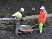 The locals turn up to backfill the wall to ensure it is both strong and watertight