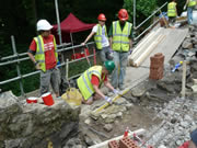 Stonework begins at the invert to the outlet, which will eventually tie into the concrete. Photo: Alan Lines