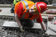 Even the coordinator gets down and working, tying steel for the main concrete slab. It was a welcome relief for the other stresses of the site... Photo: Gemma Bolton