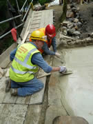 Tidying up the outlet details, where the concrete meets the earlier stonework. Photo: Alan Lines